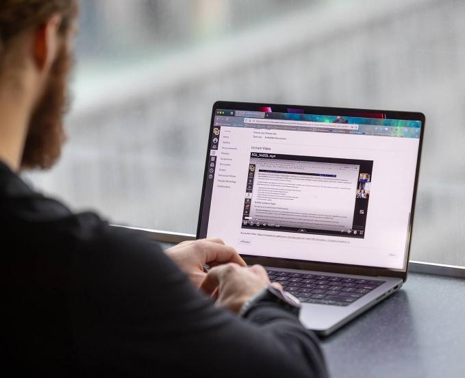 CU Denver student working in Canvas, online classroom platform, and watching a lecture