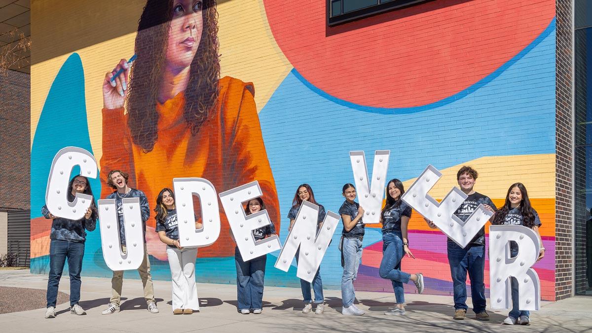 CU Denver student ambassadors holding up letters spelling CU Denver