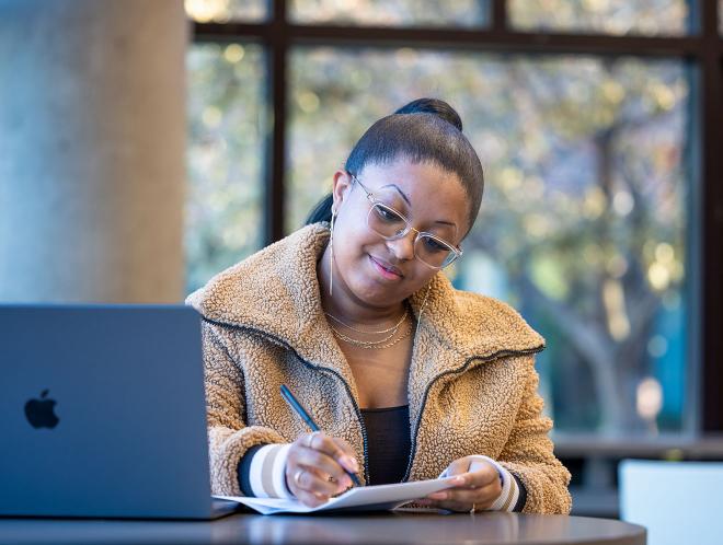 CU Denver student working in library