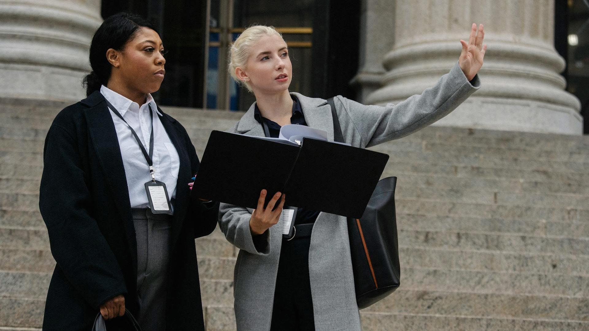 Formal businesswomen with document discussing city management