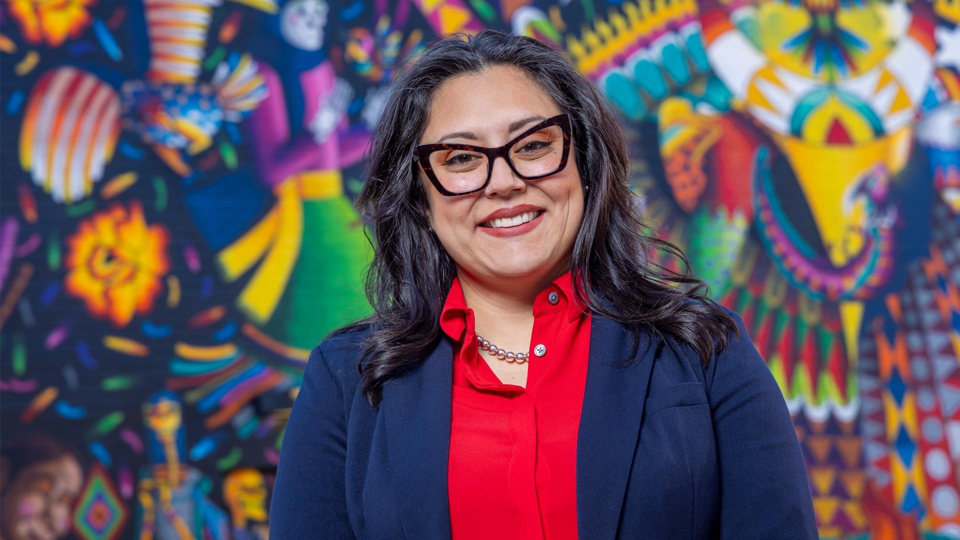 CU Denver MBA student in front of mural