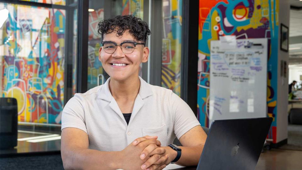 CU Denver student sitting at desk working on laptop