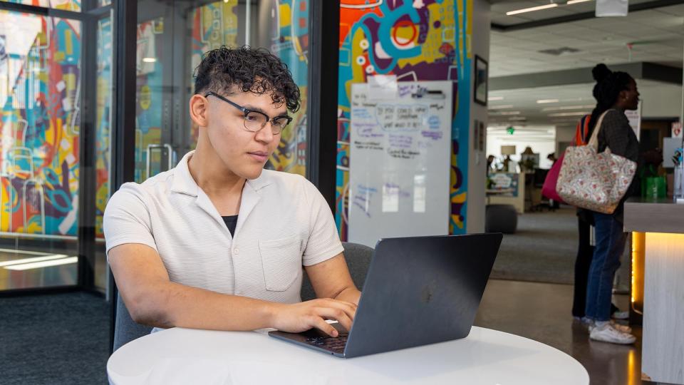 CU Denver student studying for class working on his laptop
