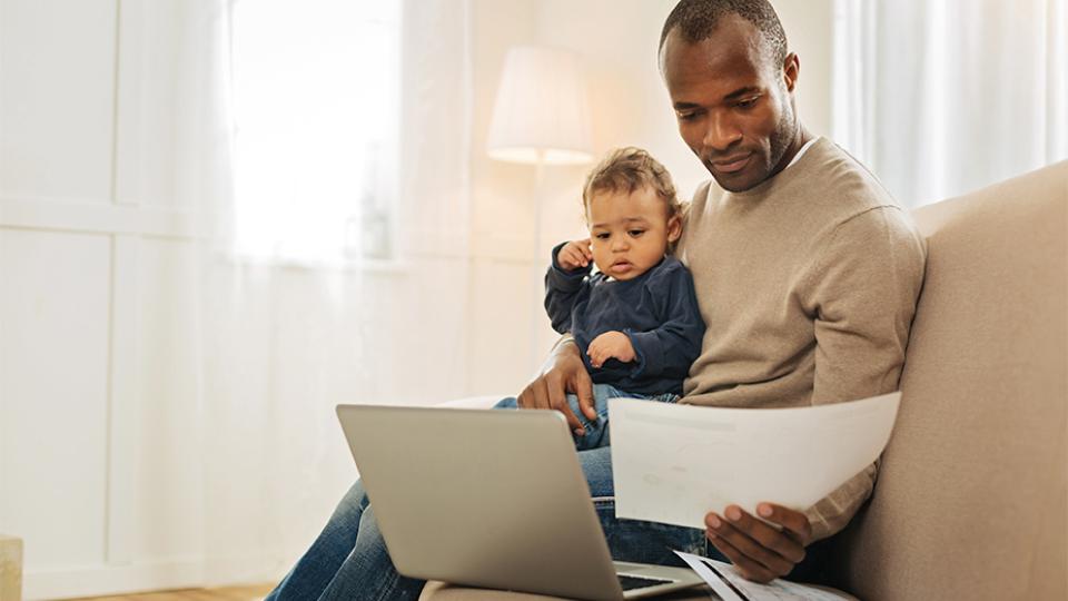 CU Denver student studying for class with child in lap