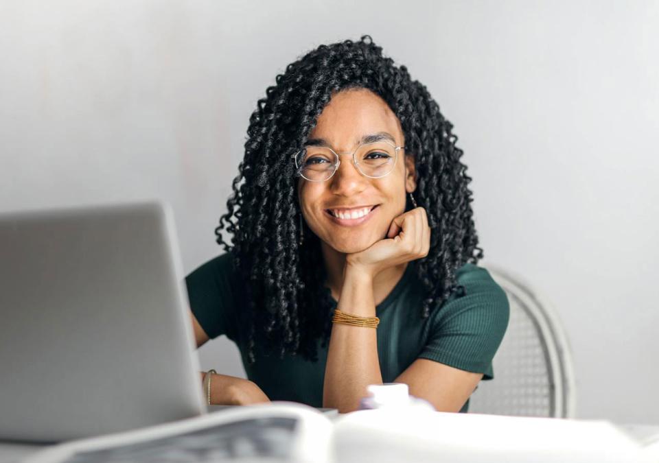 CU Denver online student smiling with laptop