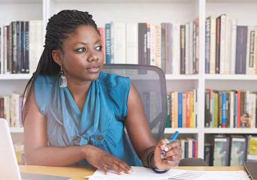 CU Denver online student working at desk