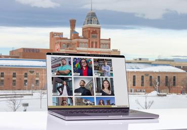 Meet Your Moment page on laptop in front of Tivoli building, Denver campus