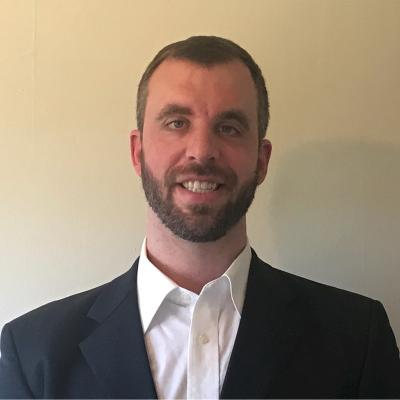 Student posing for headshot dressed in business casual attire