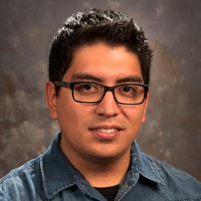 Smiling adult male student in a headshot format